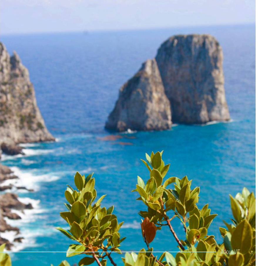 The Faraglioni sea stacks of Capri seen from the cliffs, surrounded by turquoise water